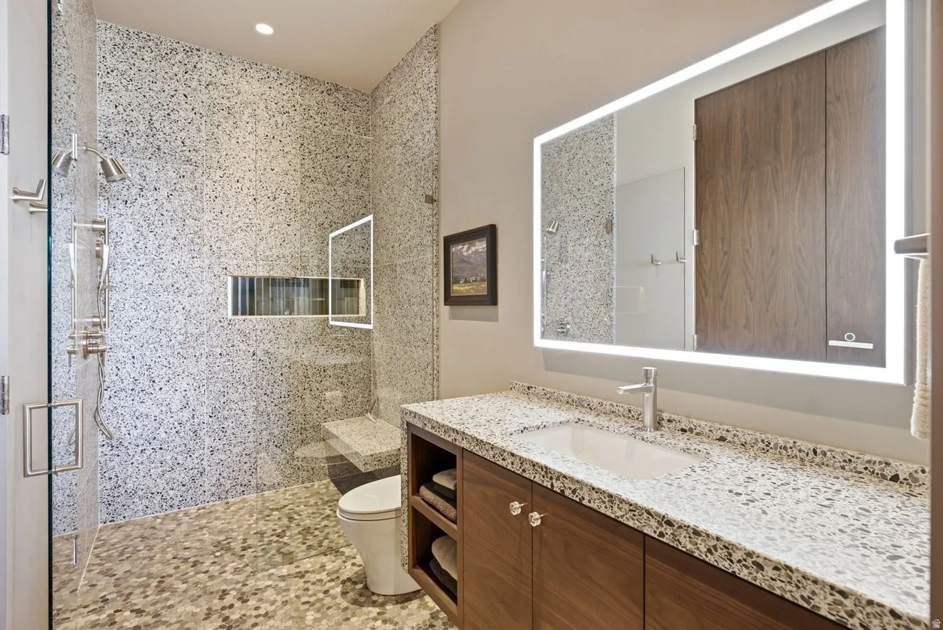 Contemporary bathroom featuring a large shower with frameless glass enclosure and mosaic tile