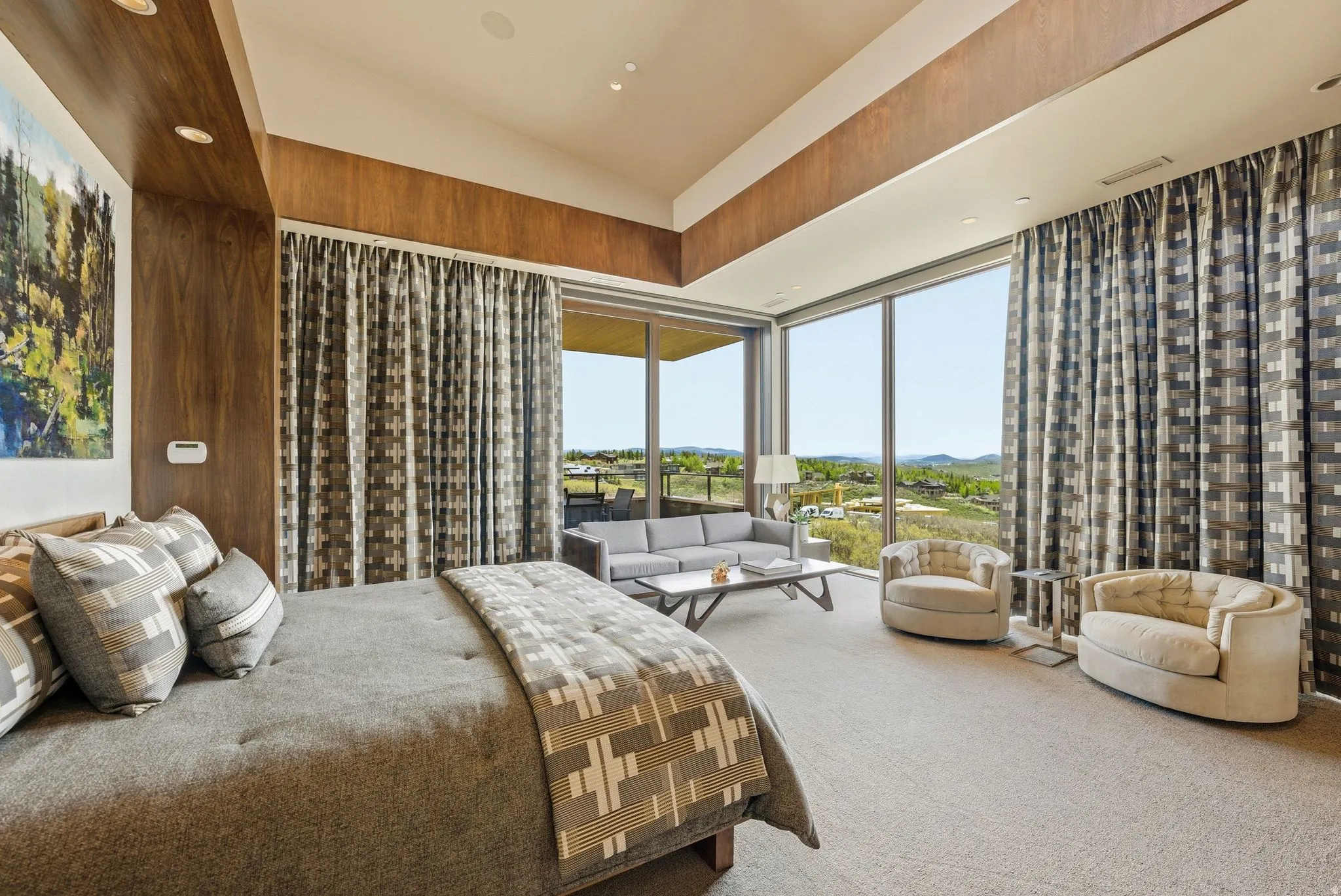 Wood-paneled accent wall, recessed lighting, expansive glass sliding doors, outdoor patio, and carpeted flooring