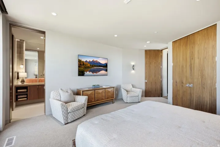 Recessed lighting, wood-finish doors, wall sconces, and built-in cabinetry