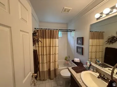 Full bathroom featuring a single vanity with a granite-style countertop, an undermount sink, and a chrome faucet