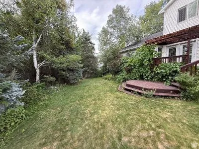 Expansive lawn area featuring a multi-level composite deck with steps