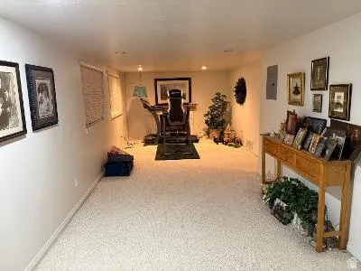 Carpeted room featuring recessed lighting and a window with horizontal blinds