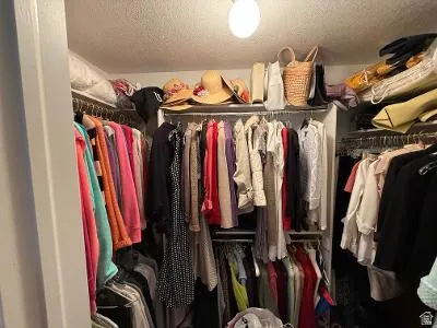 Walk-in closet featuring multiple shelving units and clothing rods for ample storage