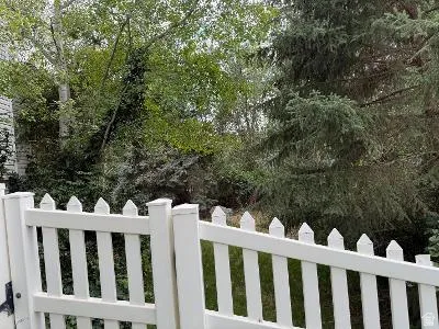 White picket fence with a pointed top design, providing a defined property boundary