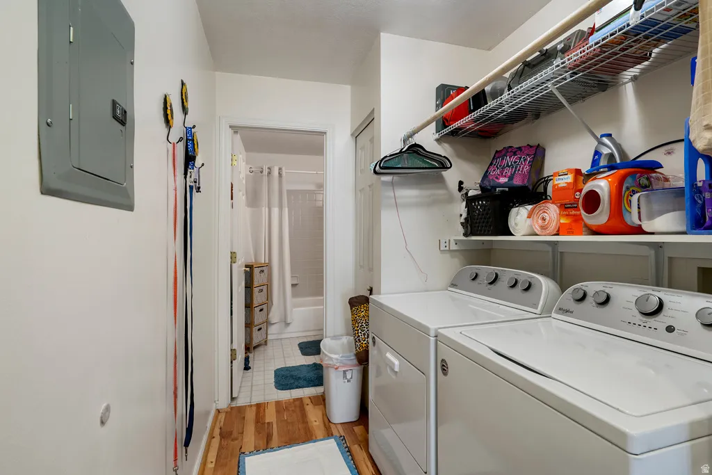 Dedicated laundry area featuring a washer and dryer, integrated wire shelving, and a hanging rod