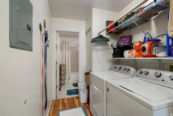 Dedicated laundry area featuring a washer and dryer, integrated wire shelving, and a hanging rod