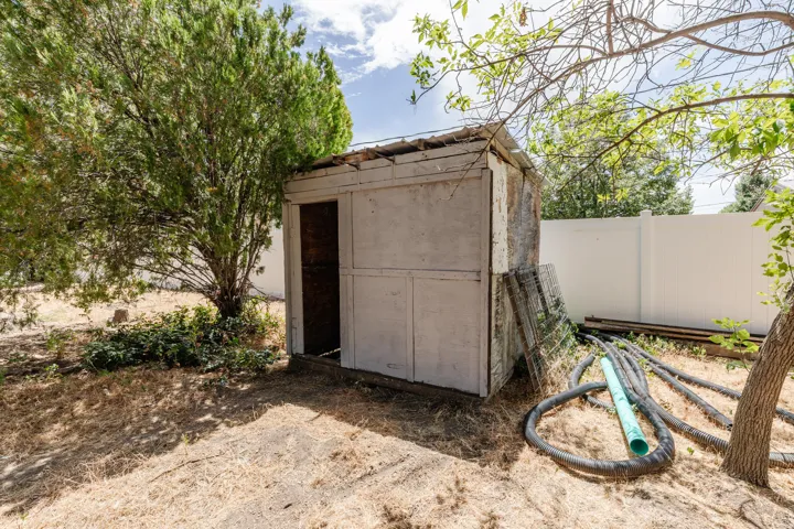 Outdoor storage shed with a partial door opening