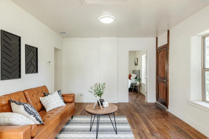 Interior living space featuring wood-finish flooring, white walls, and a ceiling-mounted light fixture
