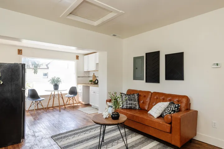 Open concept living area with wood-finish flooring