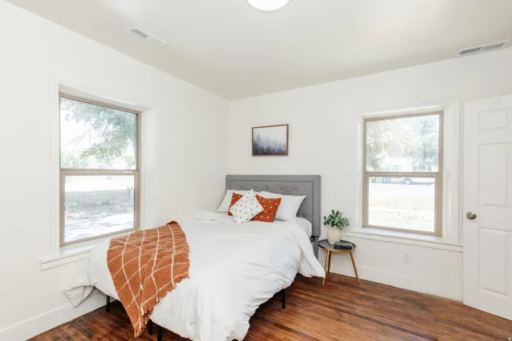 Interior room featuring wood-finish flooring, white walls, and white trim