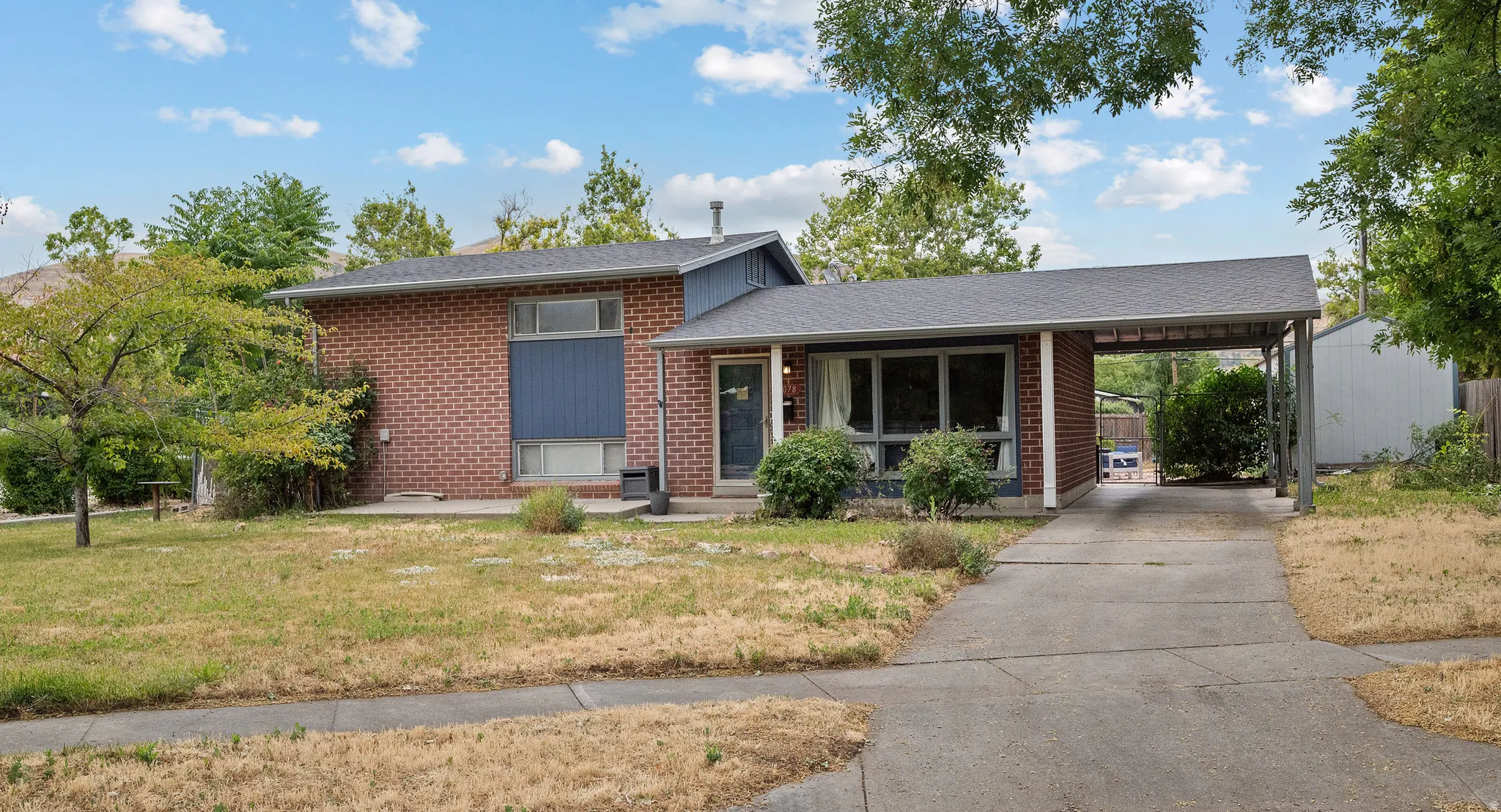 Brick exterior home with a partial blue facade accent