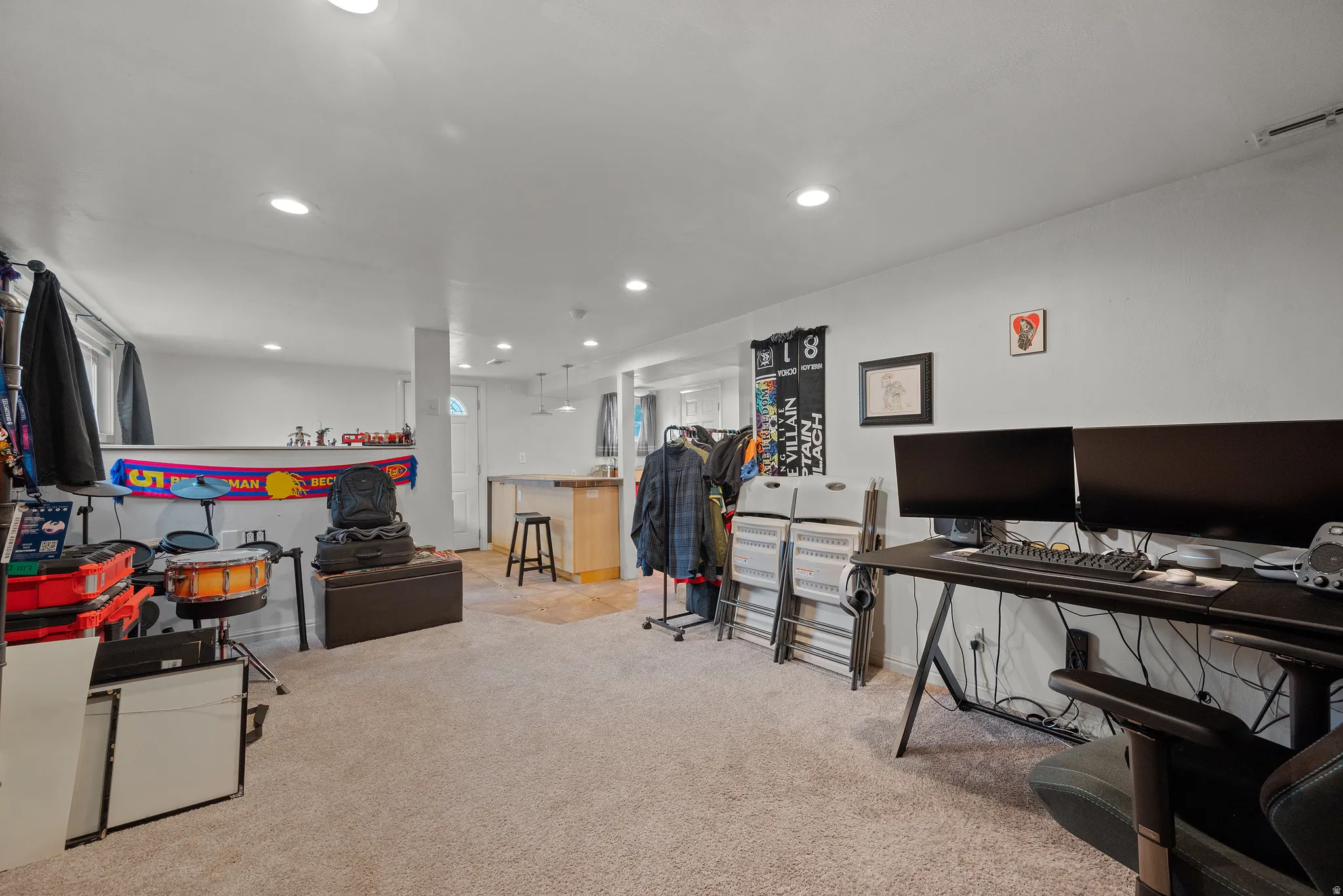 Carpeted recreation room with recessed lighting and a partial wood-finish flooring area
