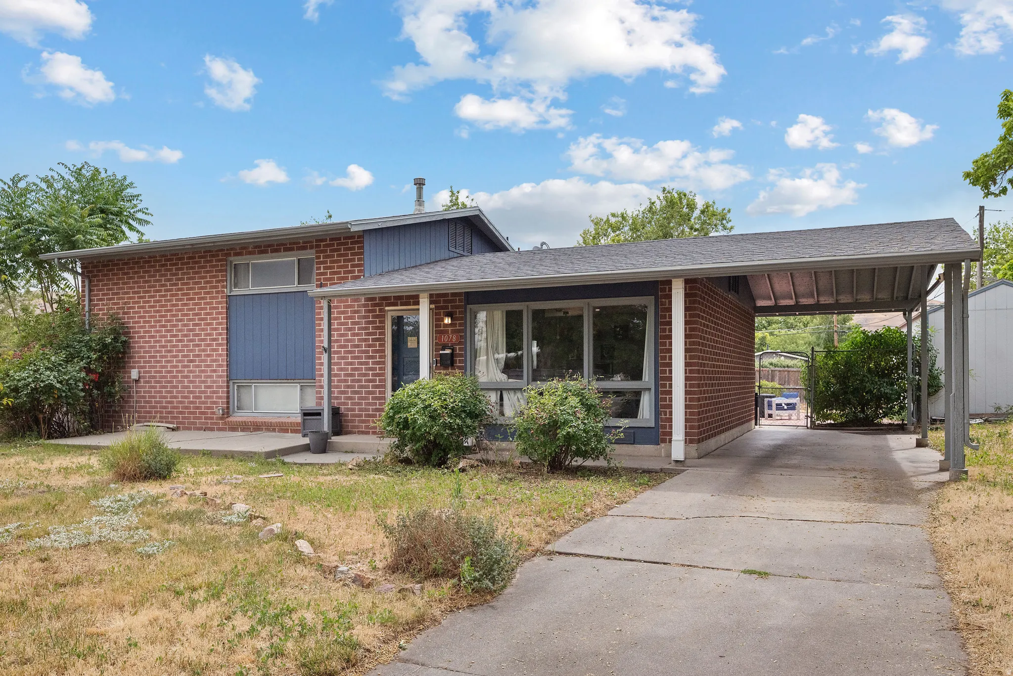 Brick exterior with a covered carport
