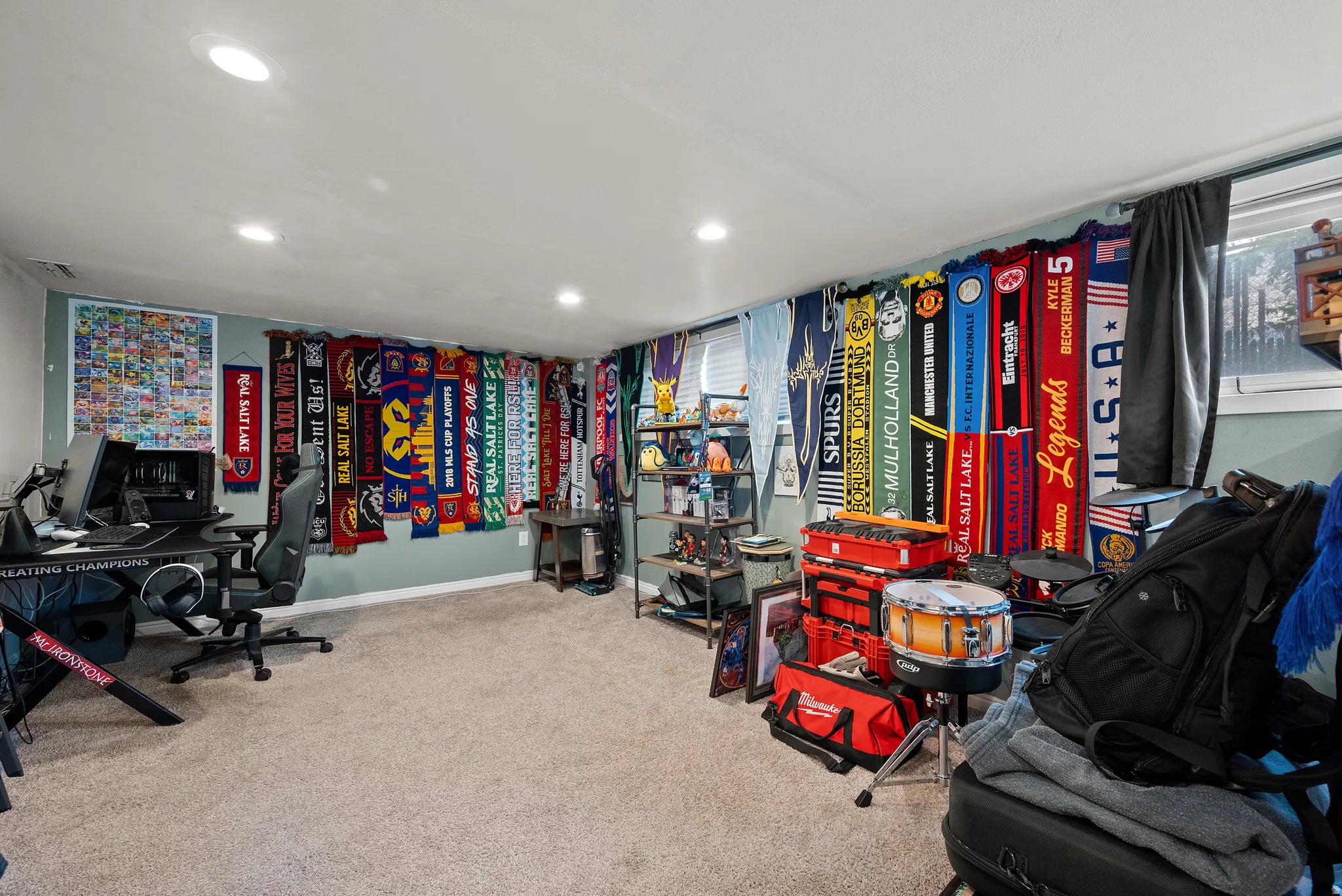 Carpeted room with recessed lighting and a window featuring blinds