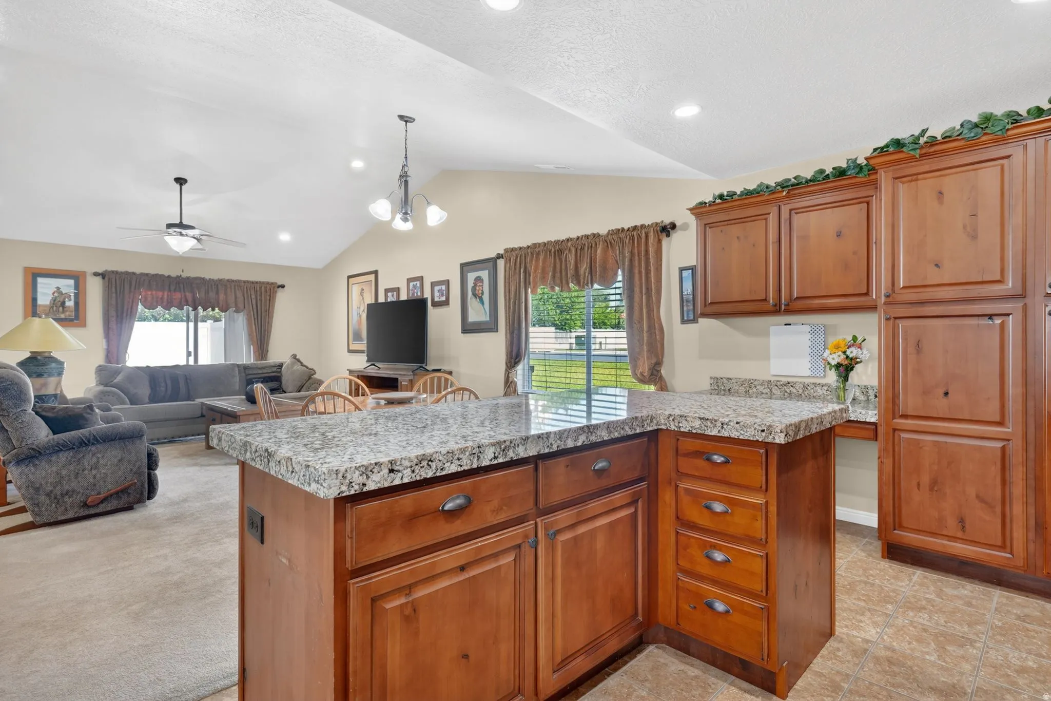 Kitchen island with granite countertops and rich wood cabinetry