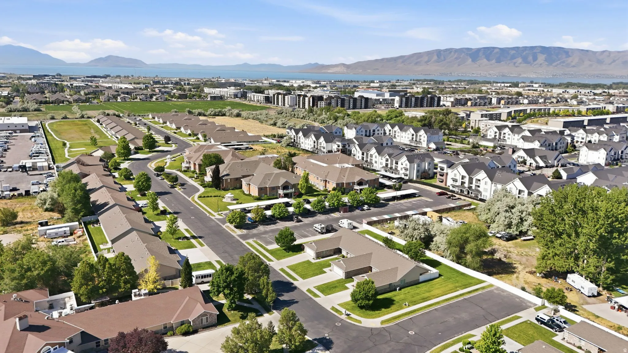 Aerial perspective showcasing a residential development with multiple single-story and multi-story homes
