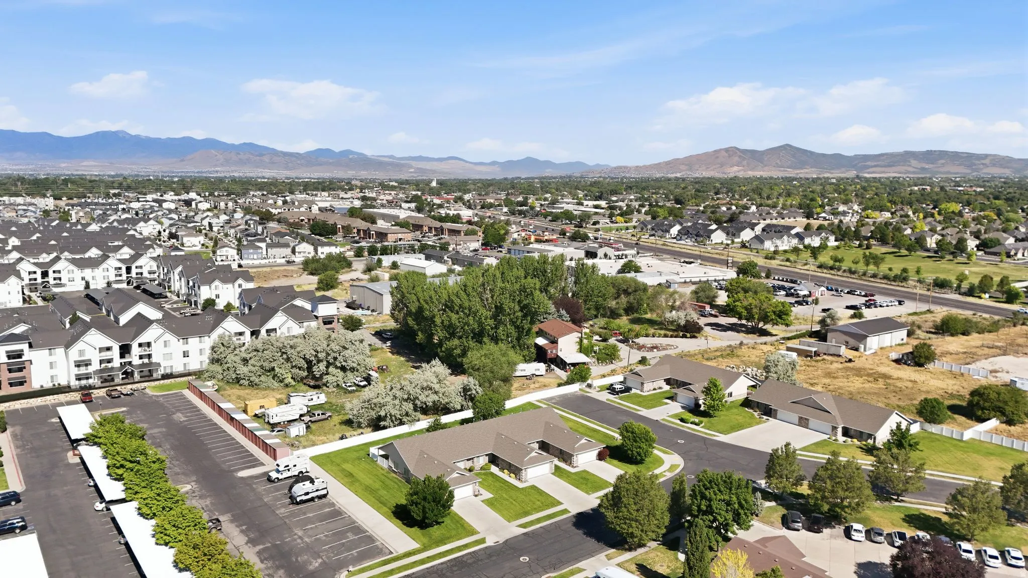 Aerial perspective showcasing a residential area with varied housing types, including multi-story apartment buildings and single-family homes