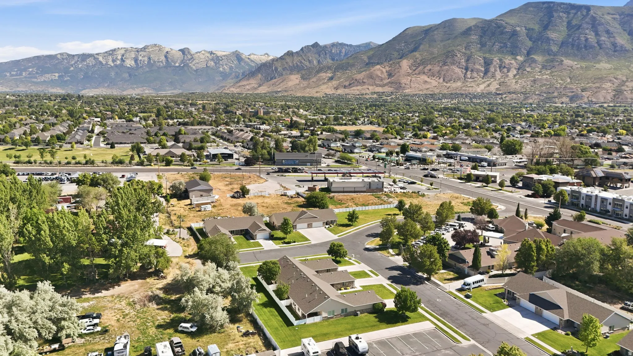 Expansive mountain backdrop framing a residential area with various housing types and green spaces