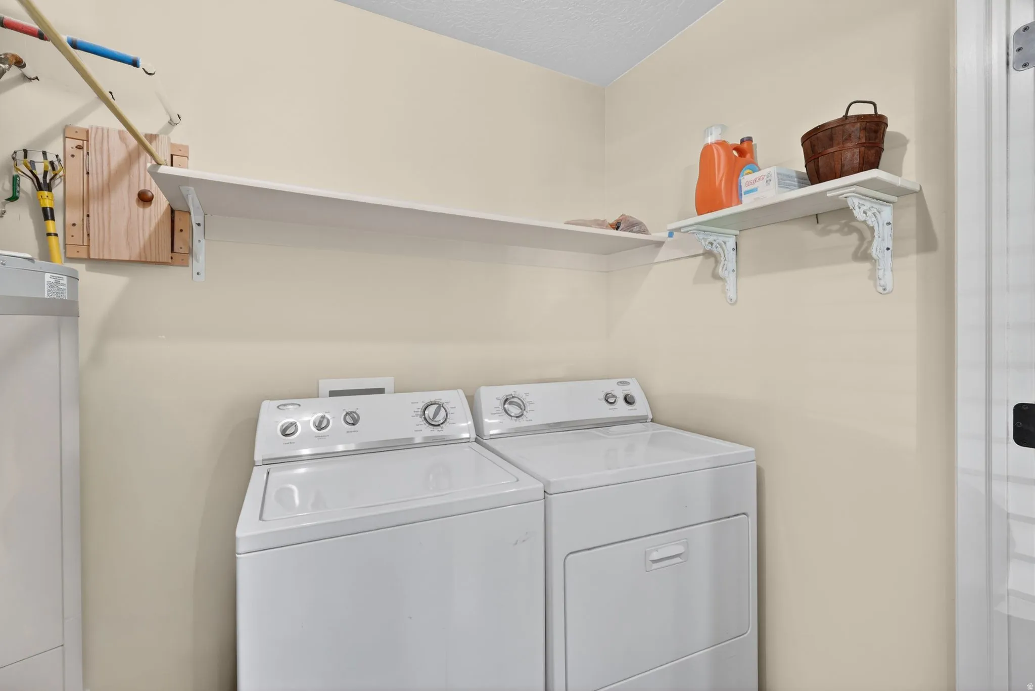 Dedicated laundry area featuring a white washing machine and dryer