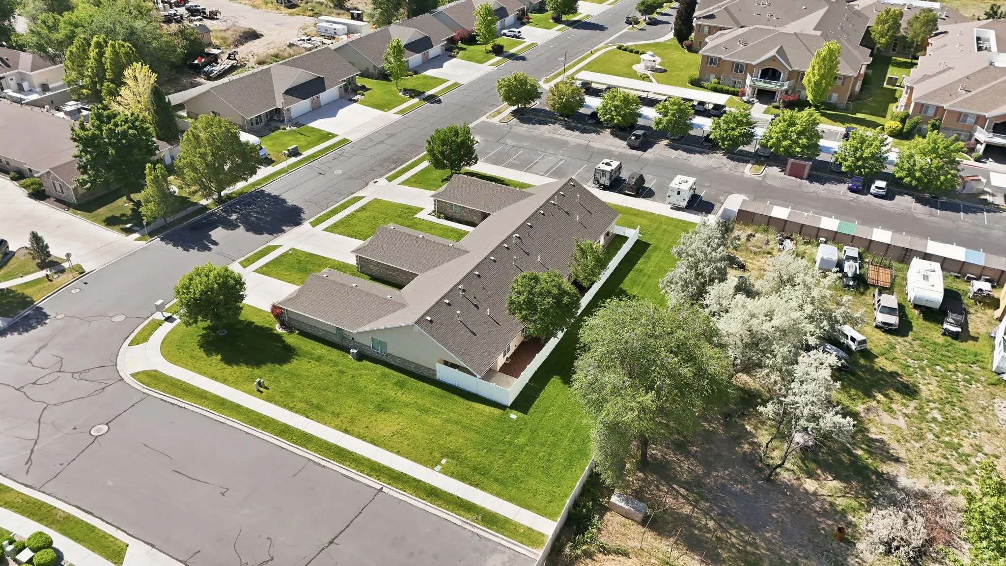 Aerial perspective showcasing a residential building with a grey shingle roof and light-colored siding