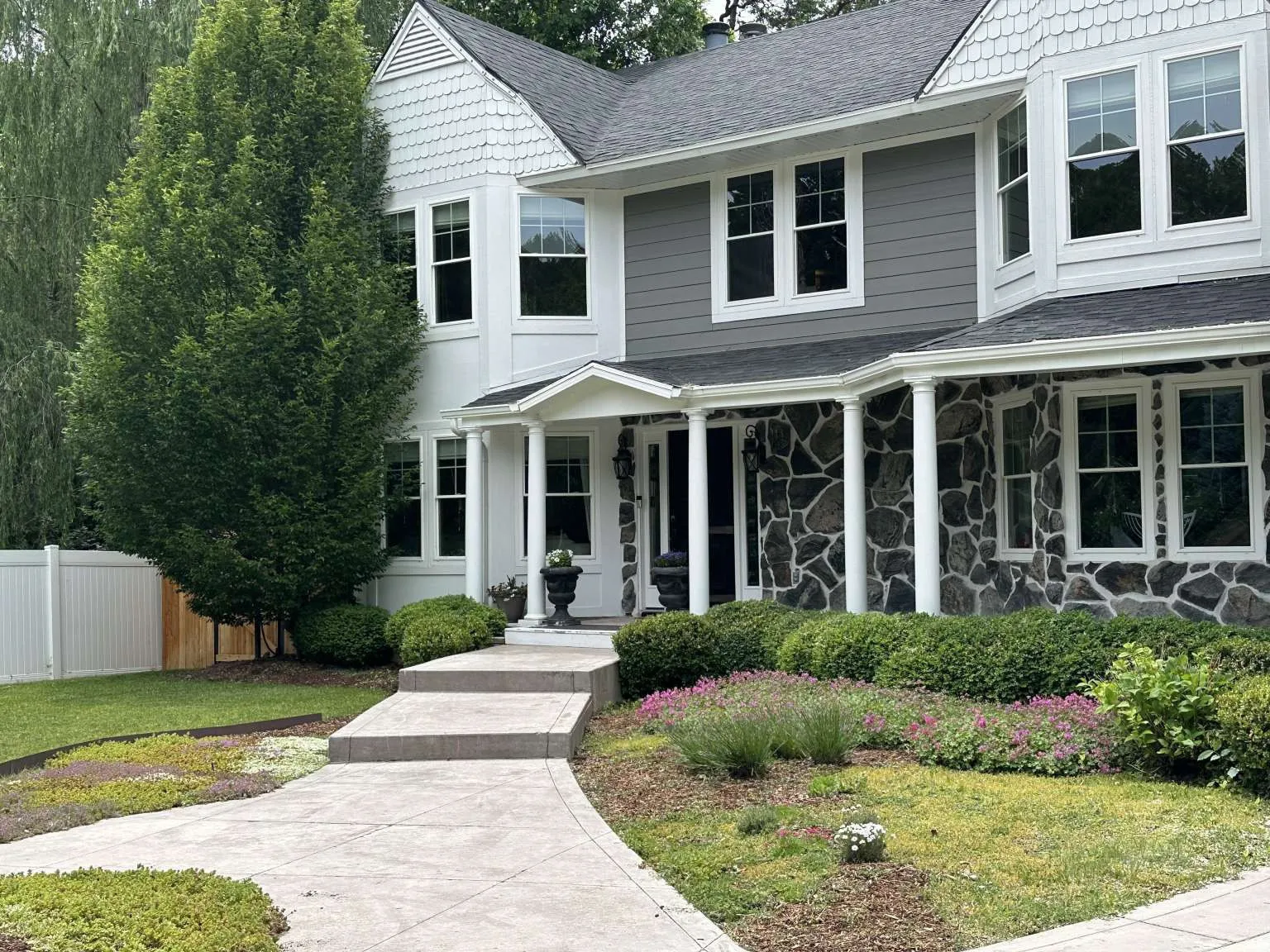 Stone and siding exterior with a prominent bay window