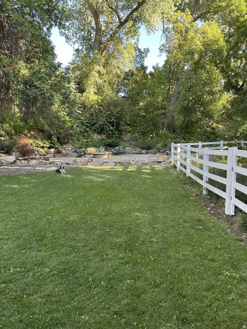 Expansive lawn bordered by a white picket fence