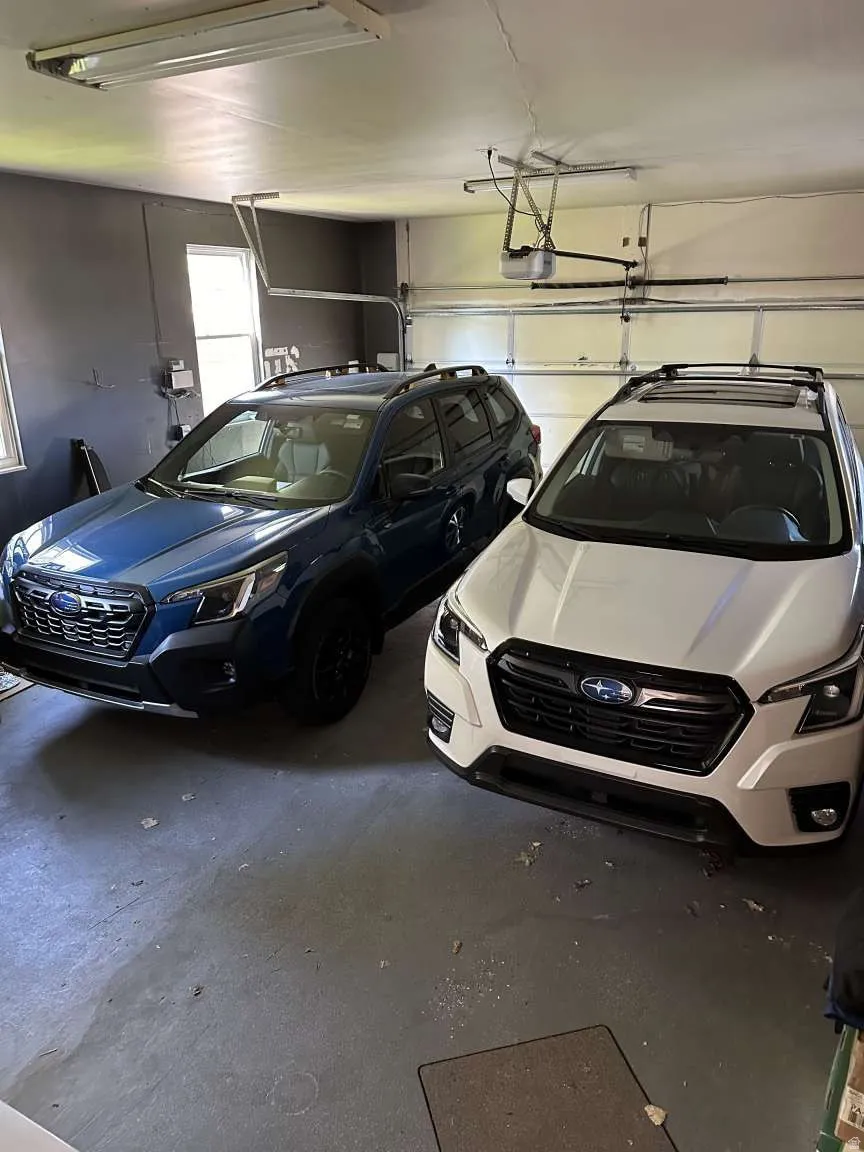 Two-car garage featuring a concrete floor and a white panel garage door