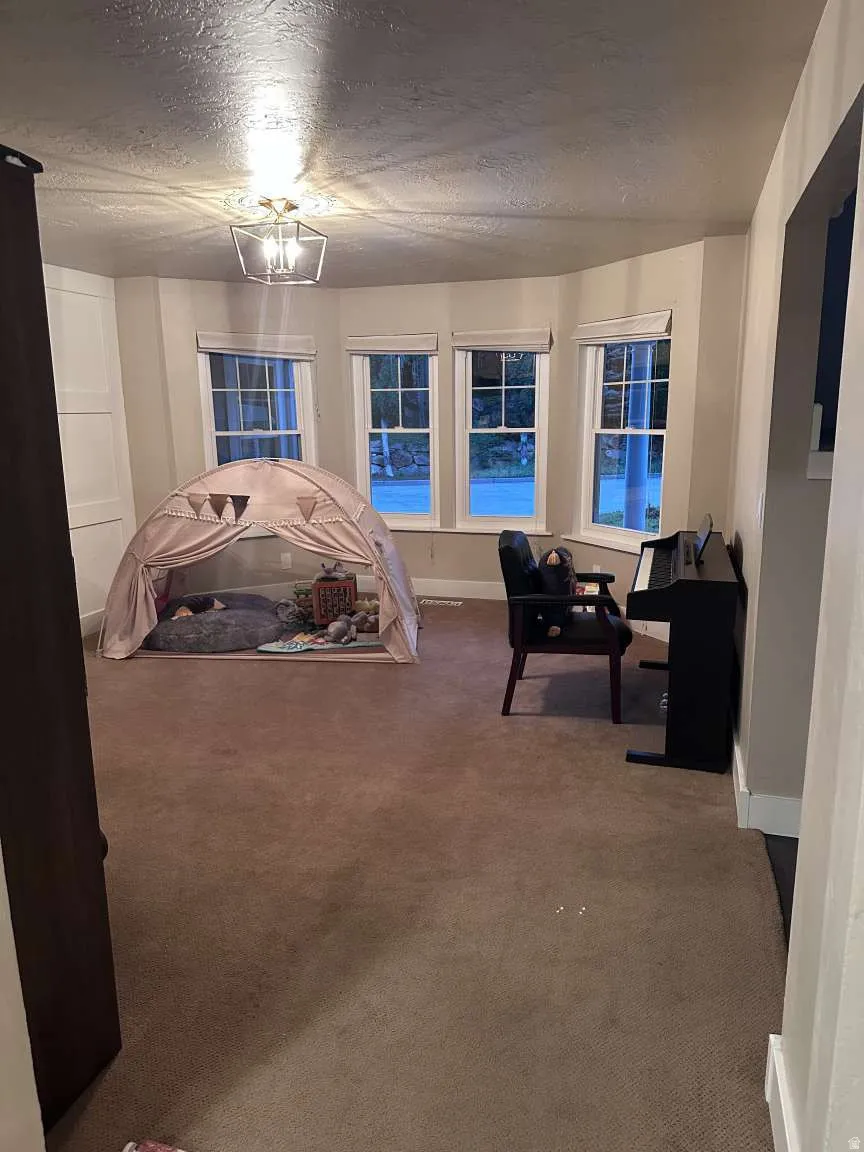 Bay window with four individual windows, recessed lighting, and carpeted flooring