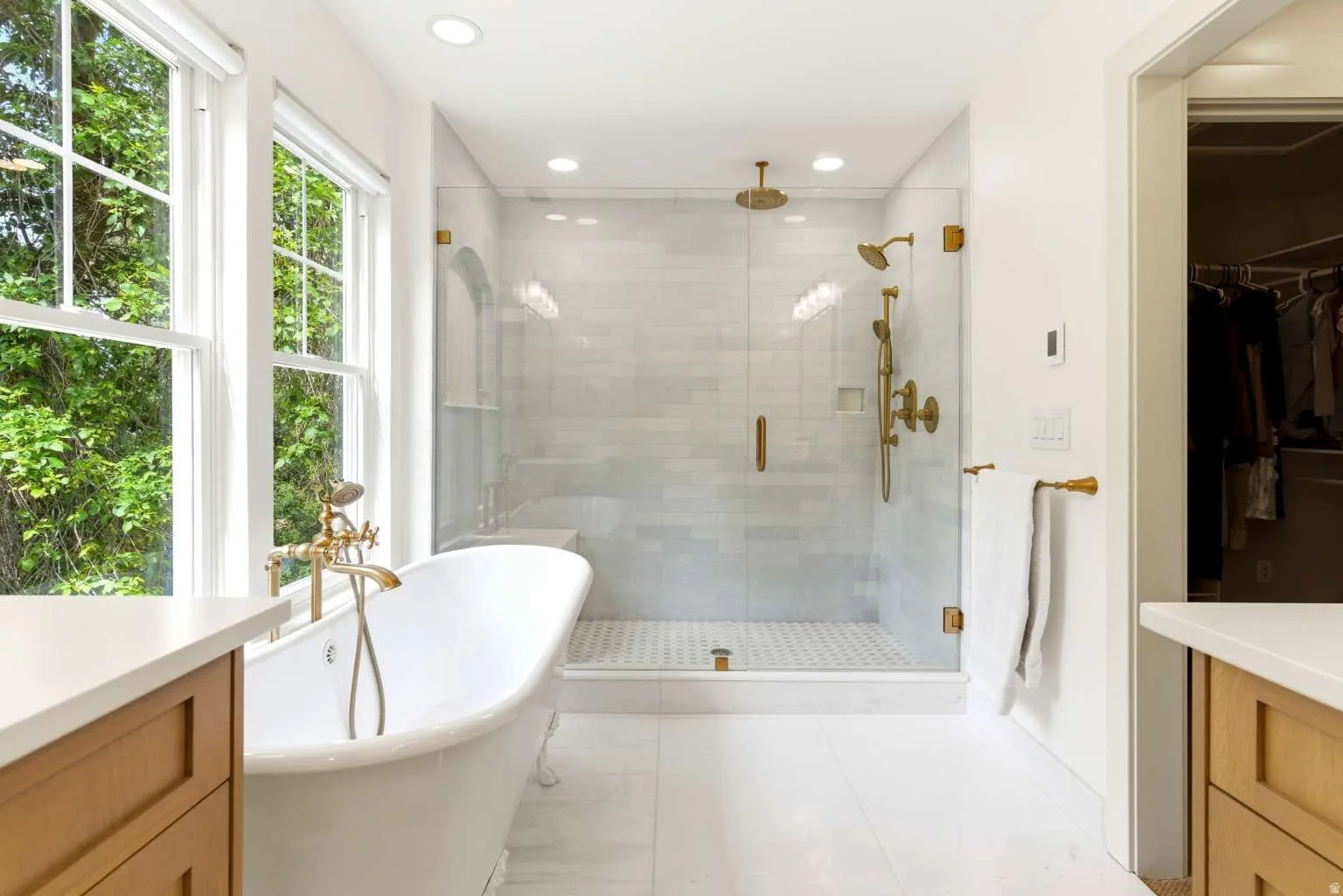 White freestanding tub with brass fixtures