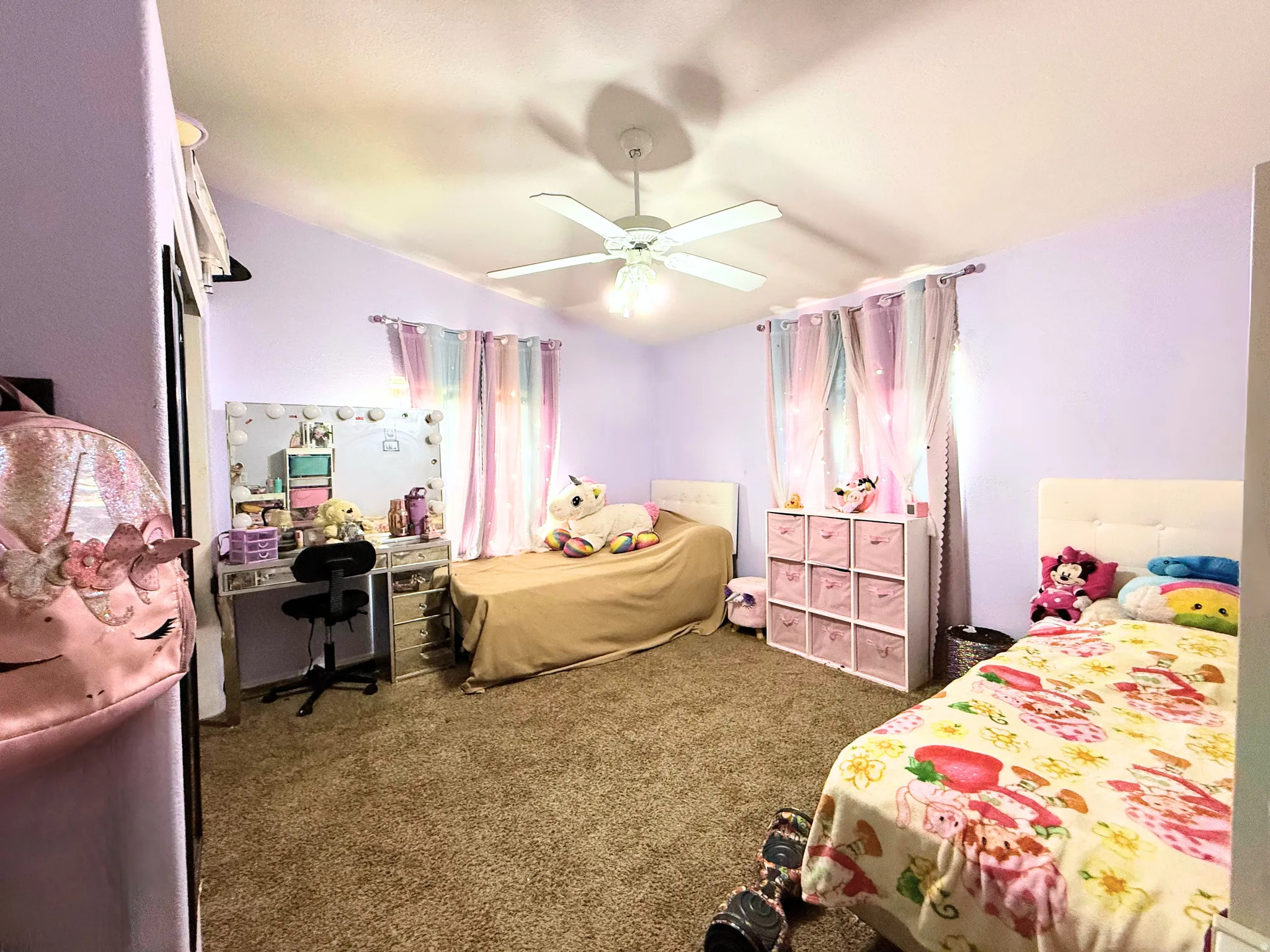 Interior room featuring vaulted ceilings and a ceiling fan with integrated lighting