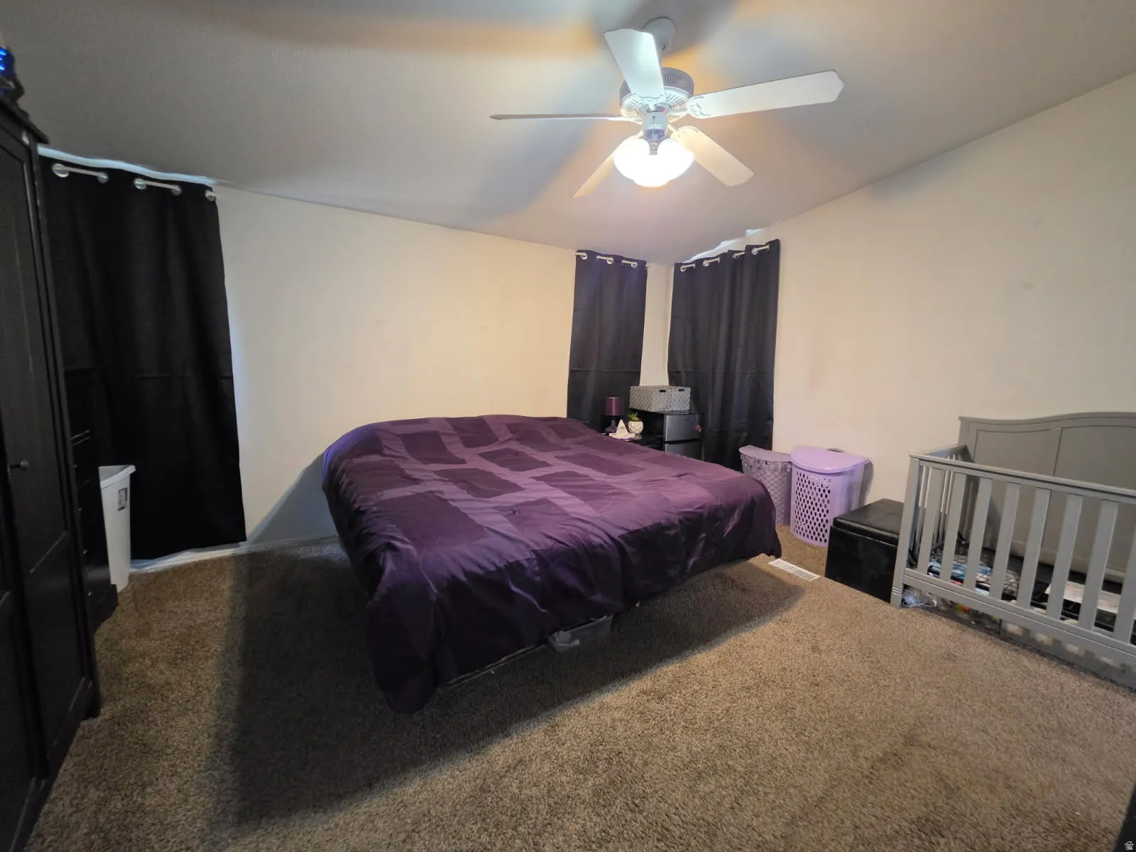Neutral-toned walls complement the carpeted flooring