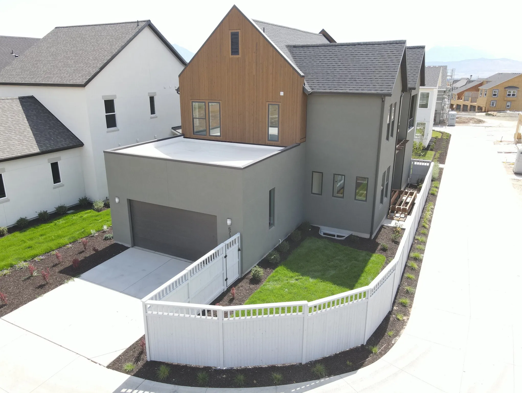 Contemporary exterior featuring a mix of painted siding and wood-finish accents
