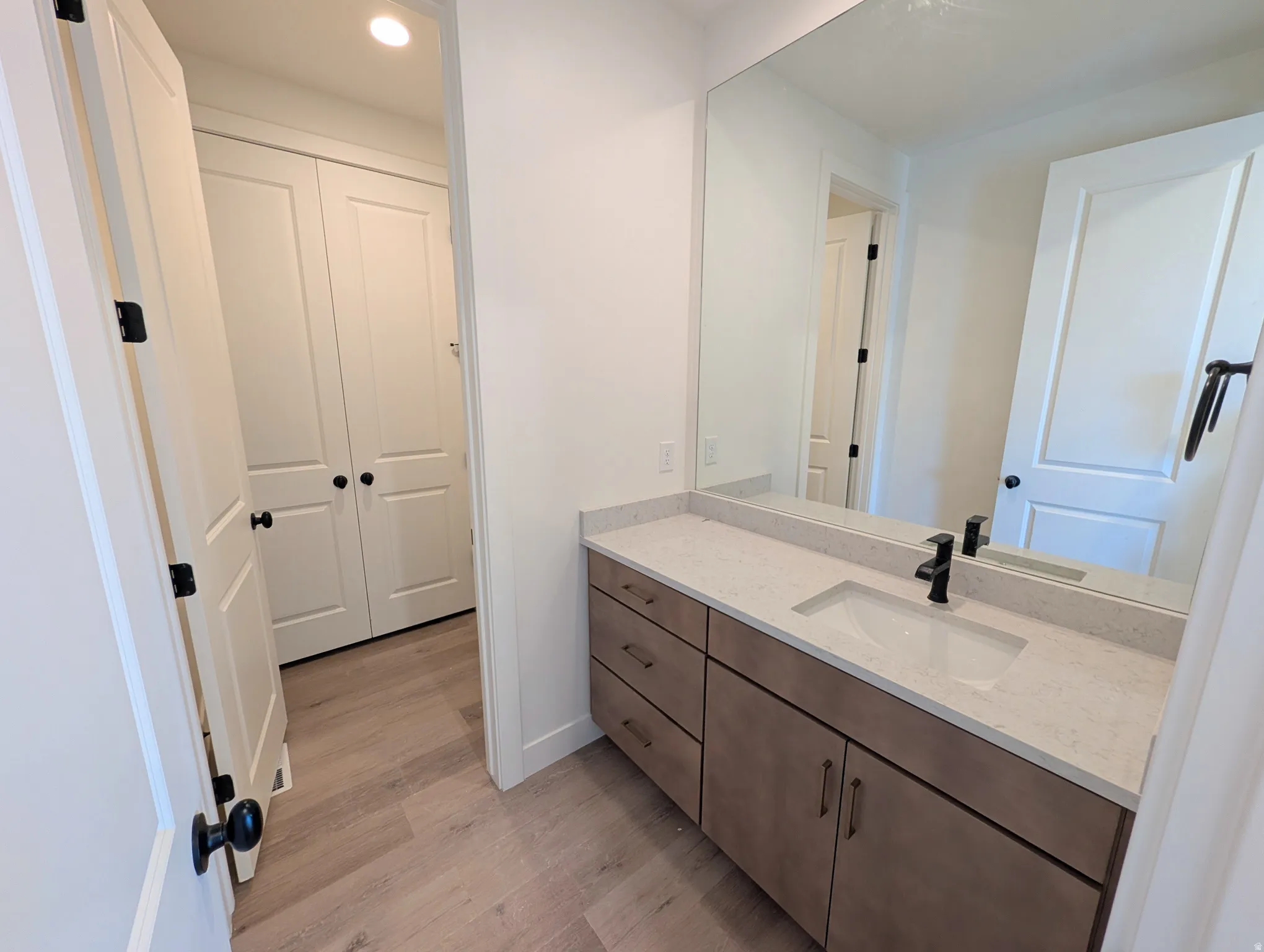 Contemporary vanity with a rectangular undermount sink and matte black faucet