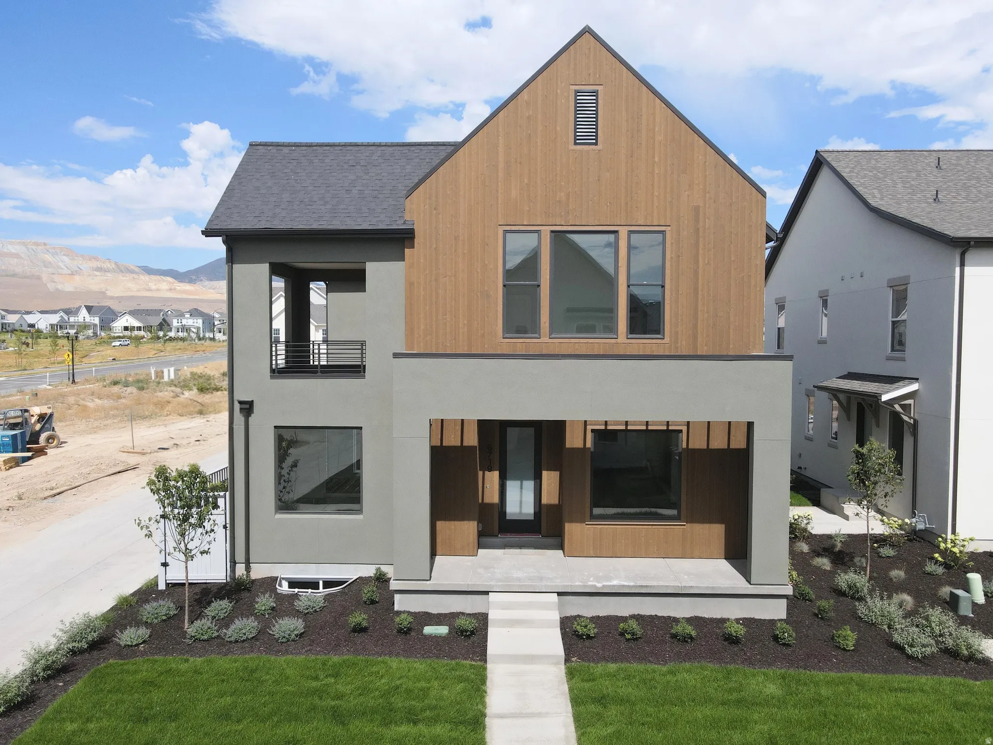 Modern architectural exterior featuring wood-finish siding and stucco