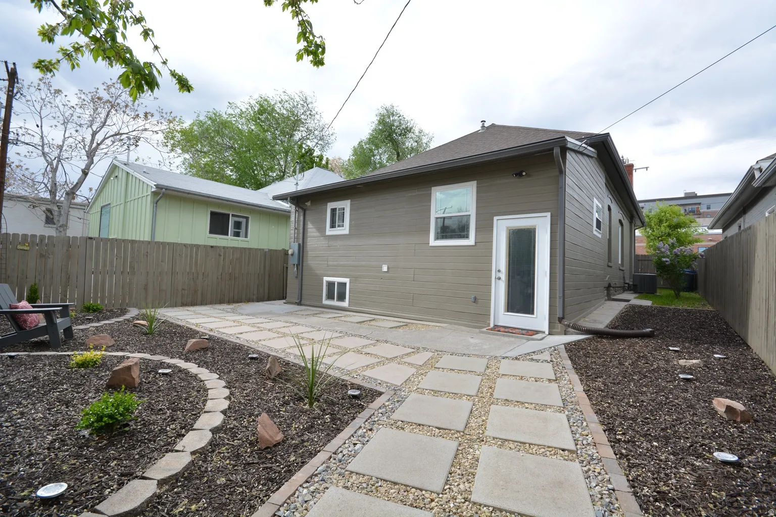Nicely decorated and planted yard with pavers.