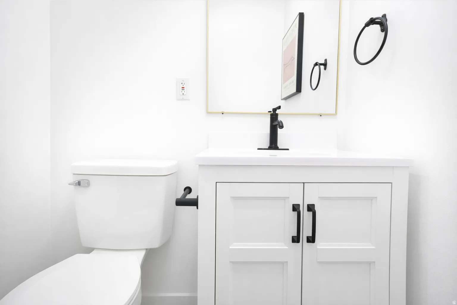 Main level half bath, one of four total bathrooms.