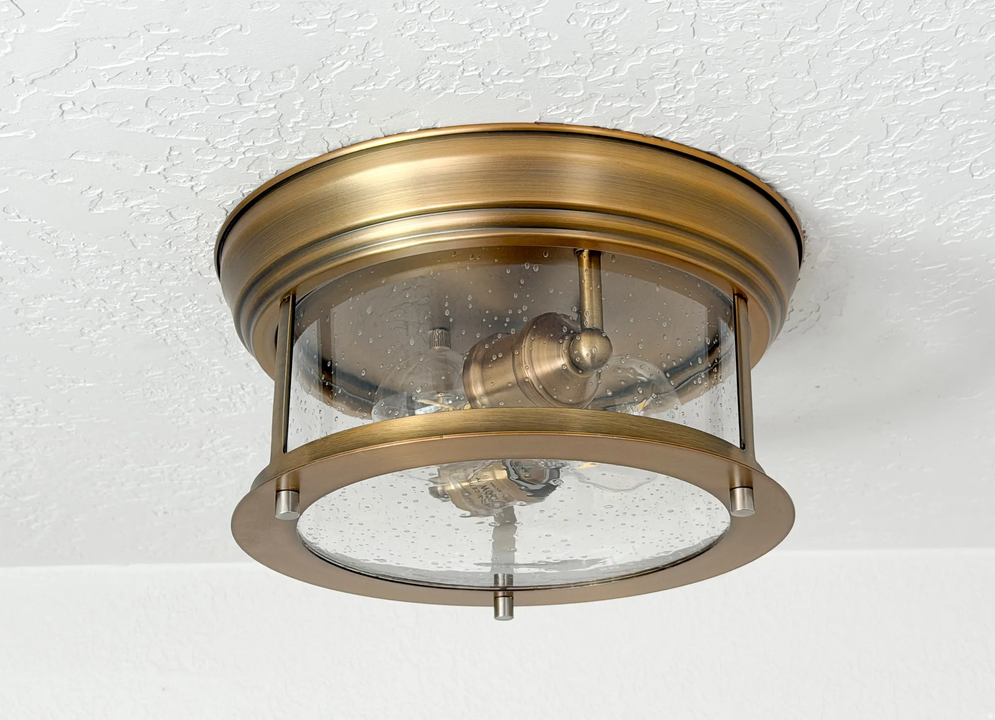 Bronze light fixture featuring seeded glass.