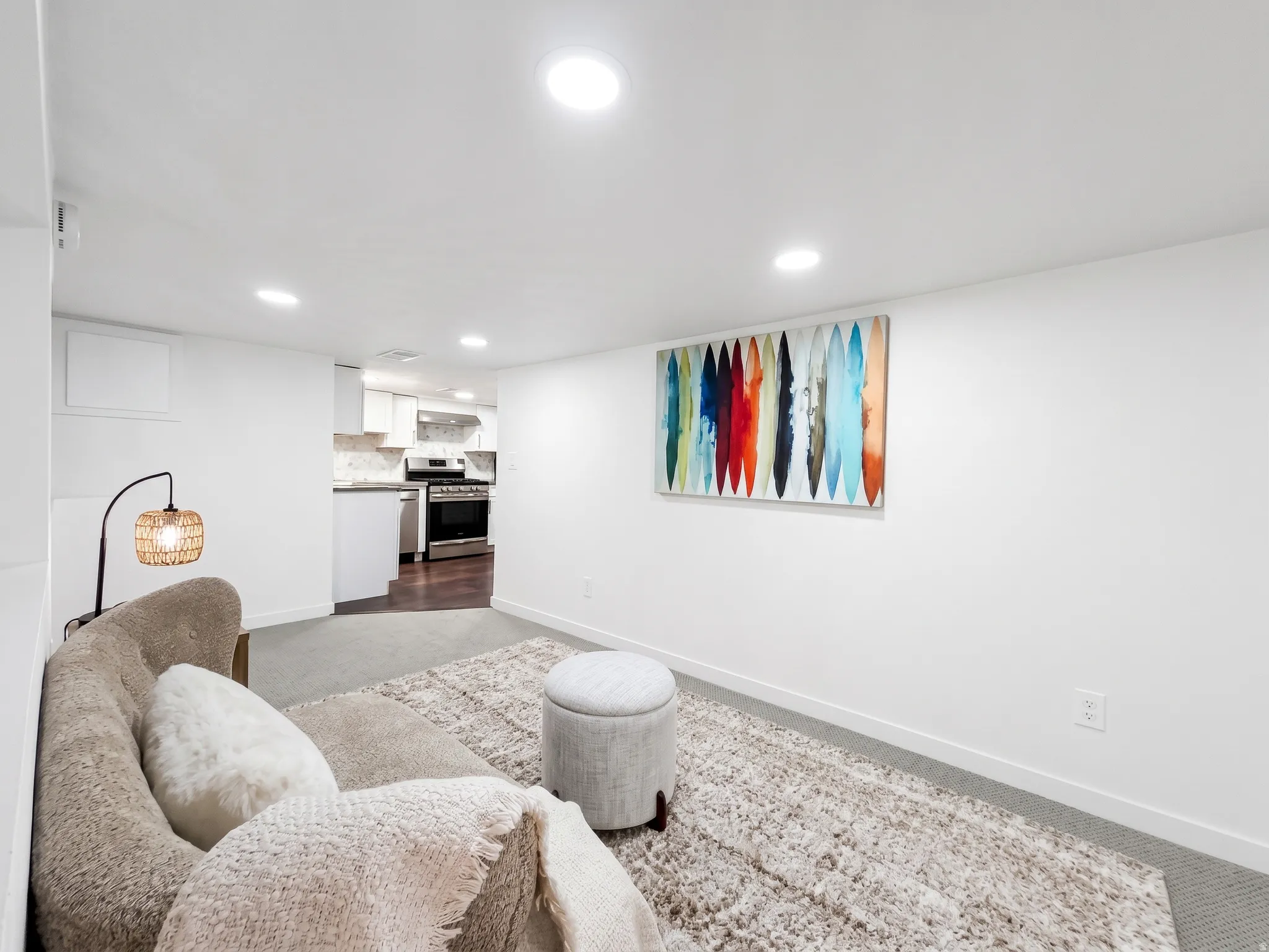 Basement family room. Basement has room 3/office/storage, recreation/family room plus full kitchen with gas stove, stainless appliances and granite countertops.