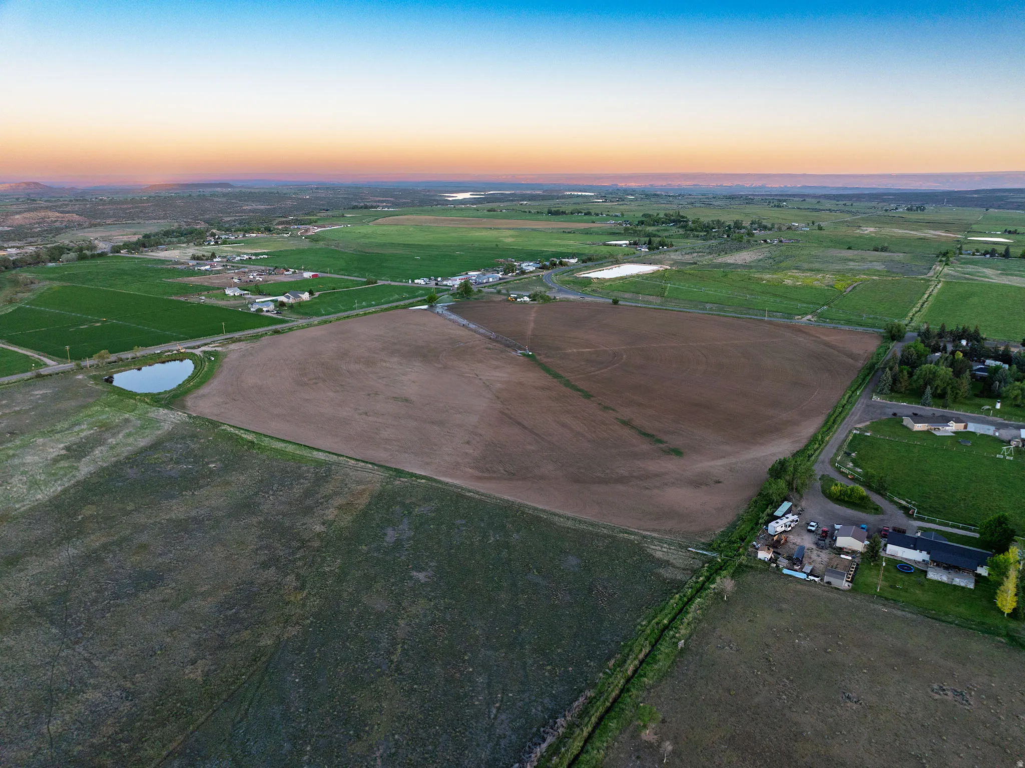 Expansive agricultural land featuring a large cultivated field