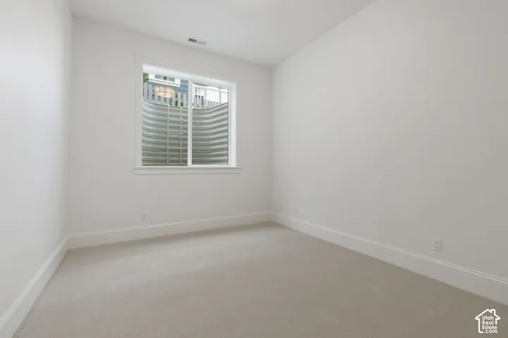 Window well, light-toned carpet, white walls, white trim, white window frame