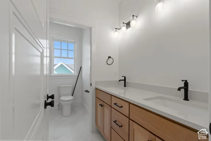 Double vanity with stone countertop and integrated sinks