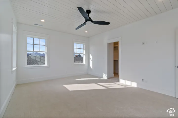 Carpeted room with a shiplap ceiling, recessed lighting, and a ceiling fan