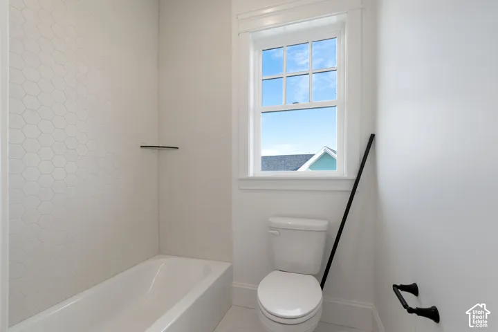 White bathtub with hexagonal tile surround