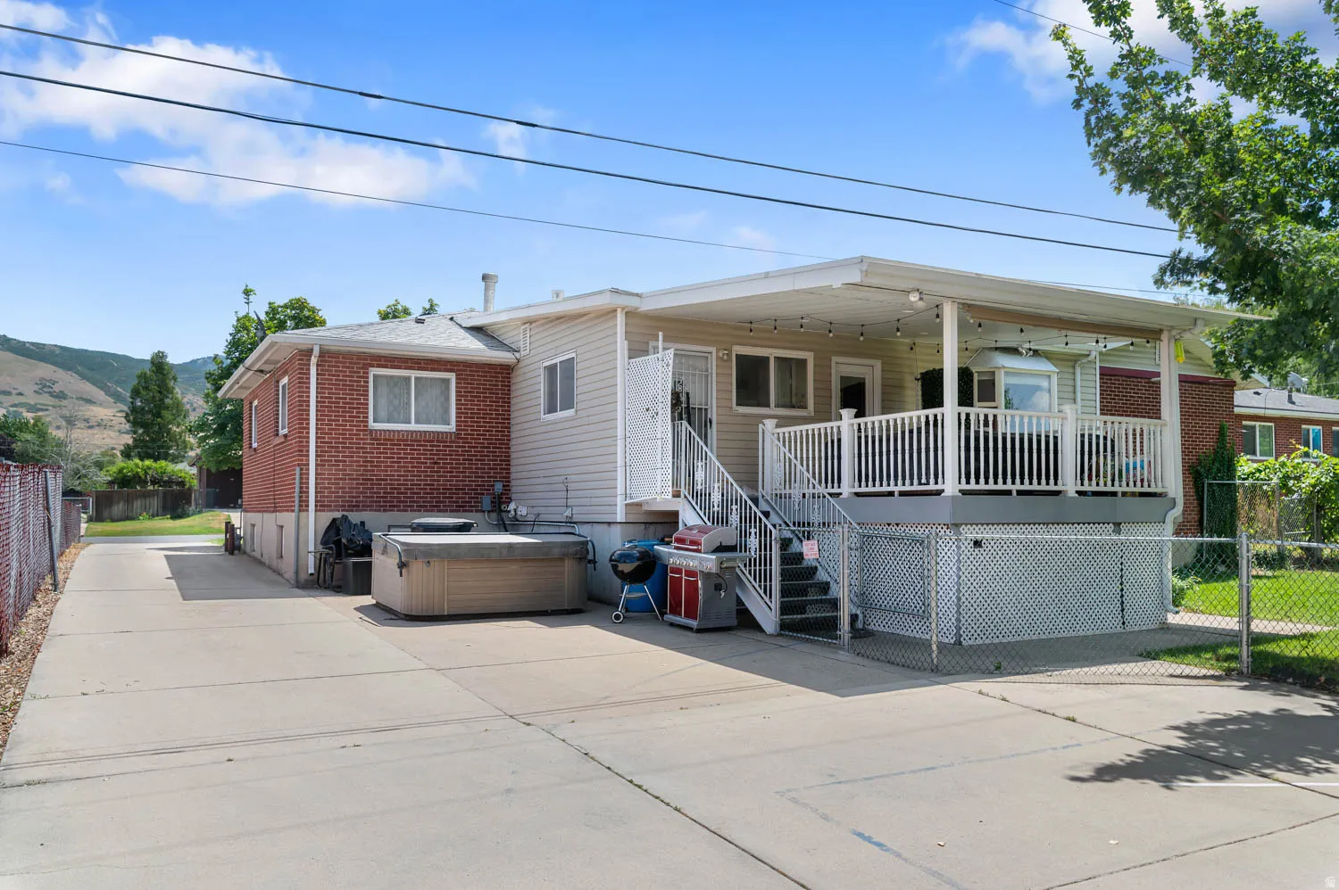 Expansive concrete driveway alongside a brick and siding exterior