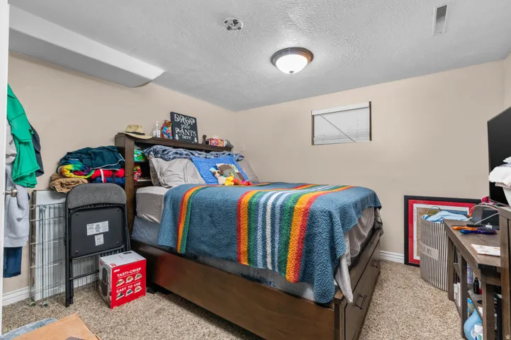Carpeted room featuring a window with blinds, recessed ceiling light, and neutral wall paint