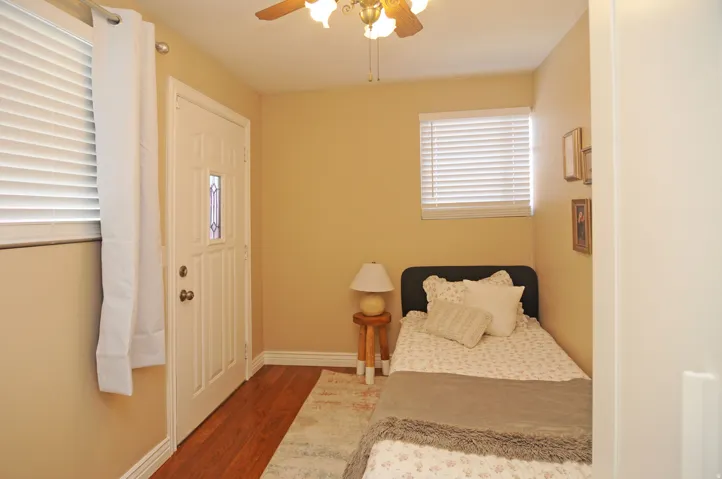 Wood-finish flooring, ceiling fan, and window blinds