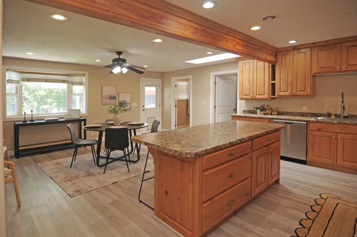 Kitchen featuring wood cabinetry, stainless steel appliances, a center island with countertop, and recessed lighting