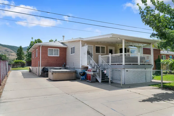 Expansive concrete driveway alongside a brick and siding exterior