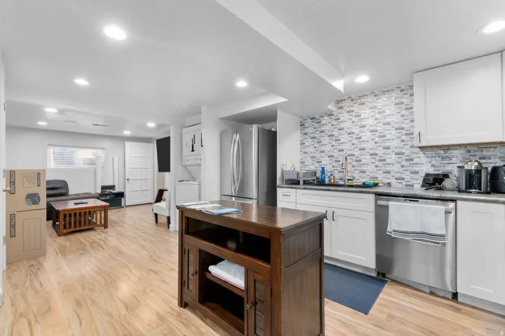 Open concept living area featuring wood-finish flooring