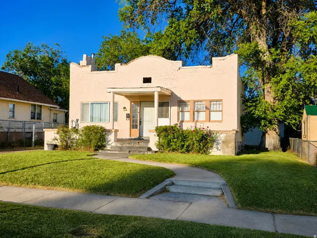 Pink stucco exterior with an arched parapet